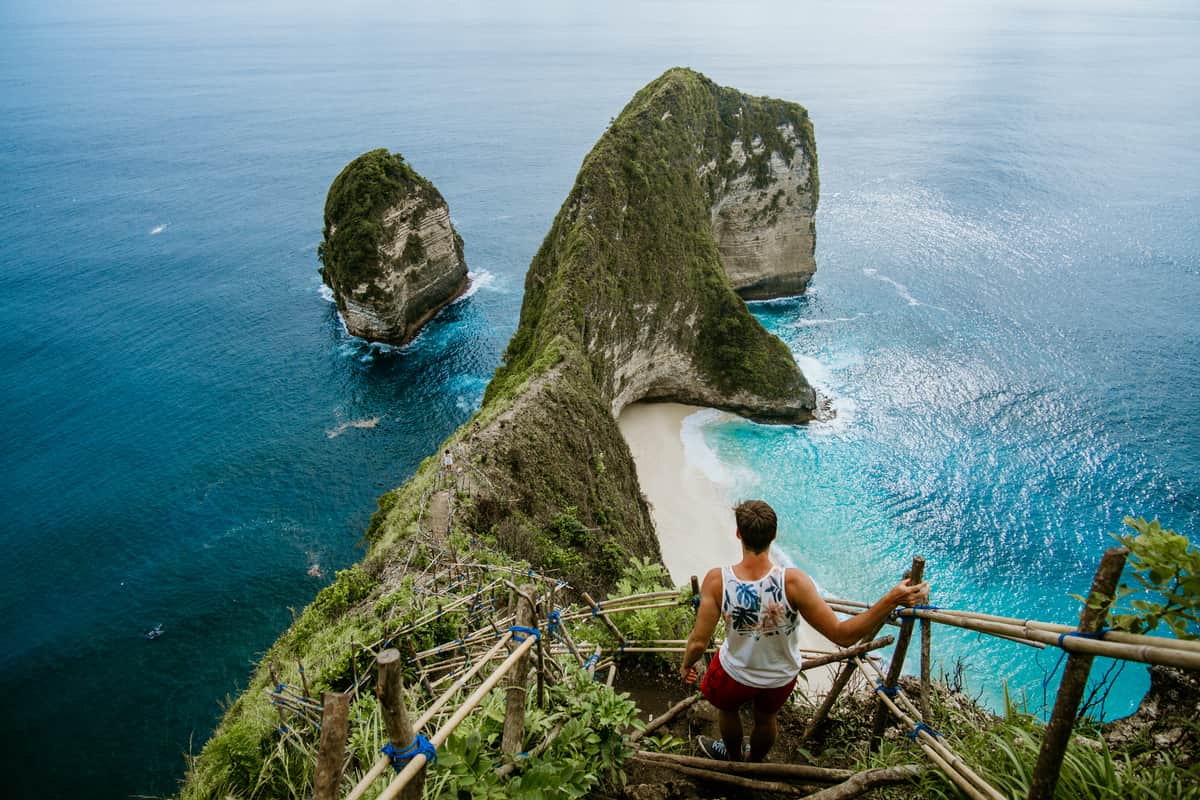 Man hiking with view of a mountain peak.