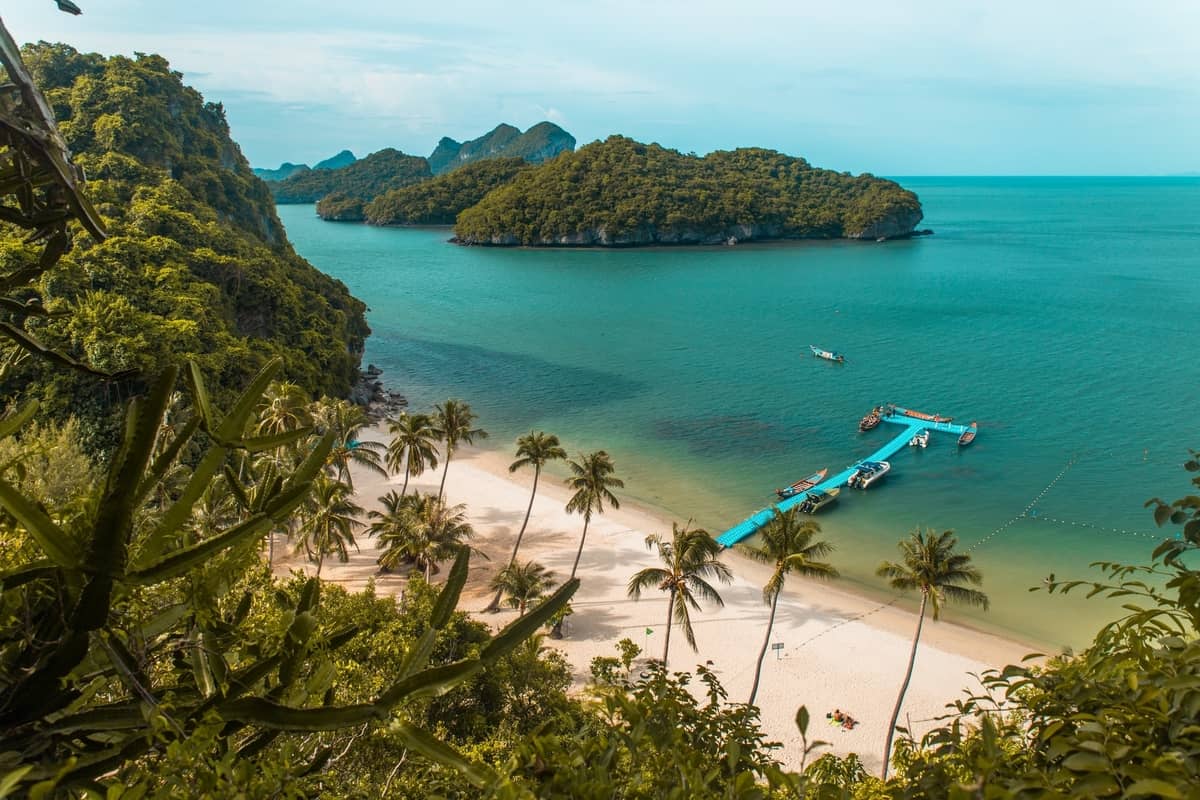 Clear turquoise waters with lush hills.