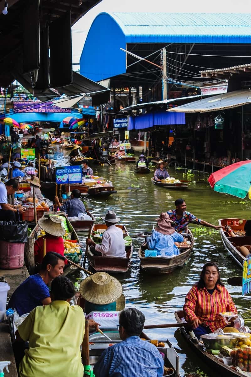 Bustling floating market with colorful stalls.