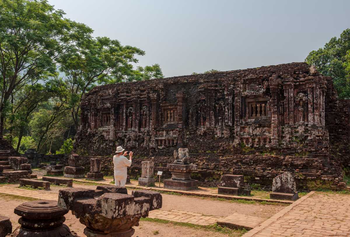 Ancient temple ruins overgrown with trees.