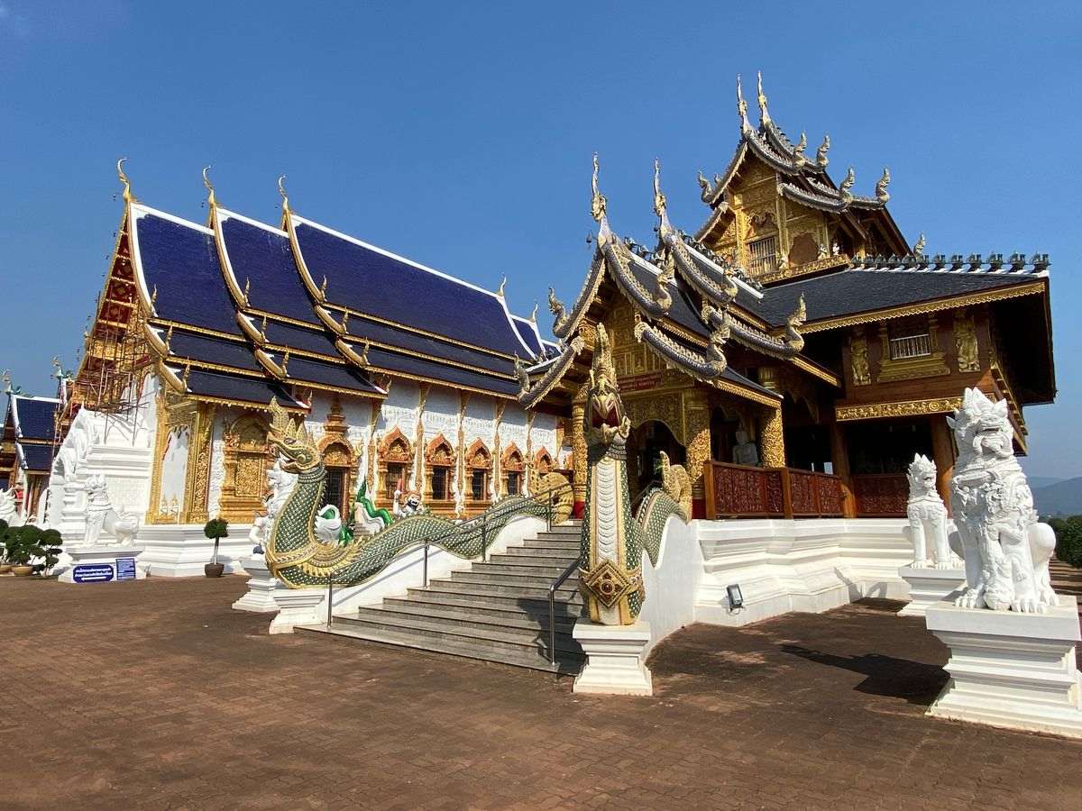 Thai temple with reflective floor and spires.