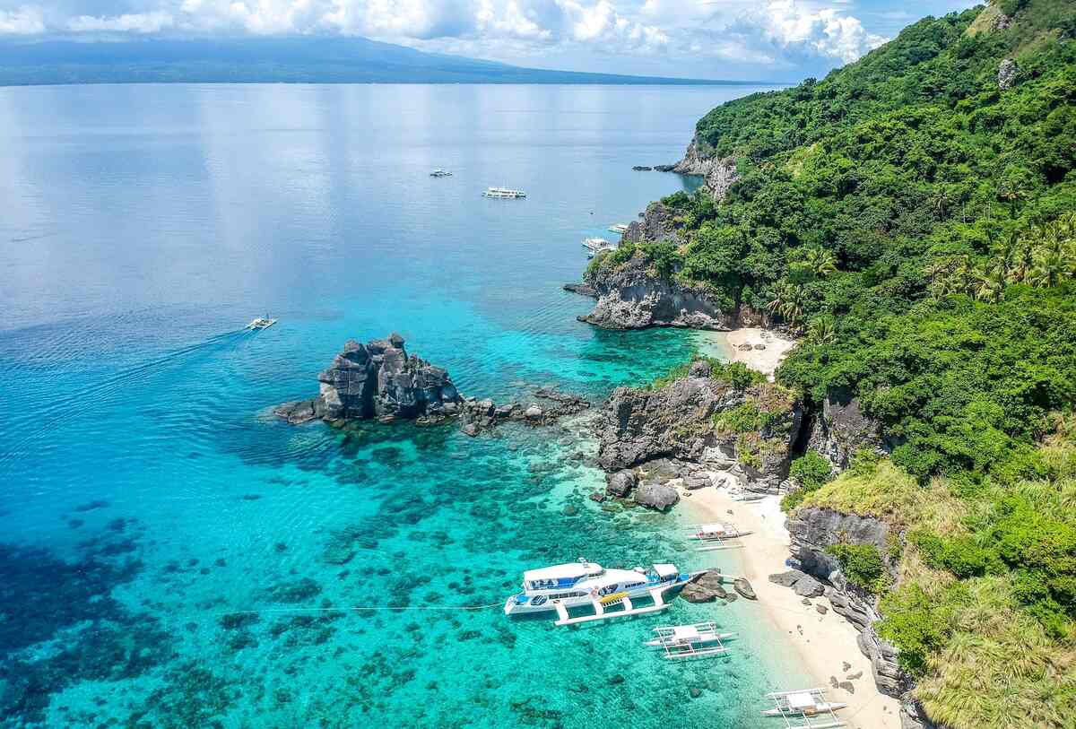 Rocky island beach with clear blue water.