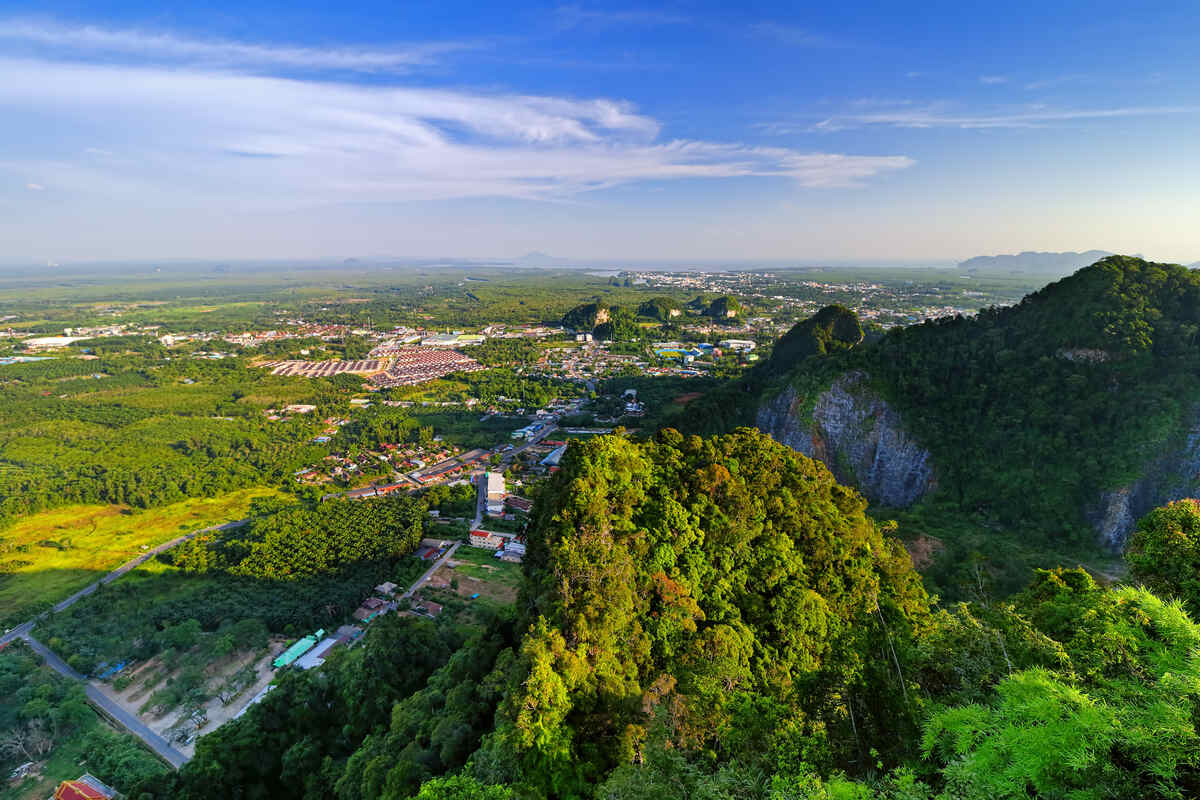 An aerial view of a rural landscape with fields, trees, and a settlement.