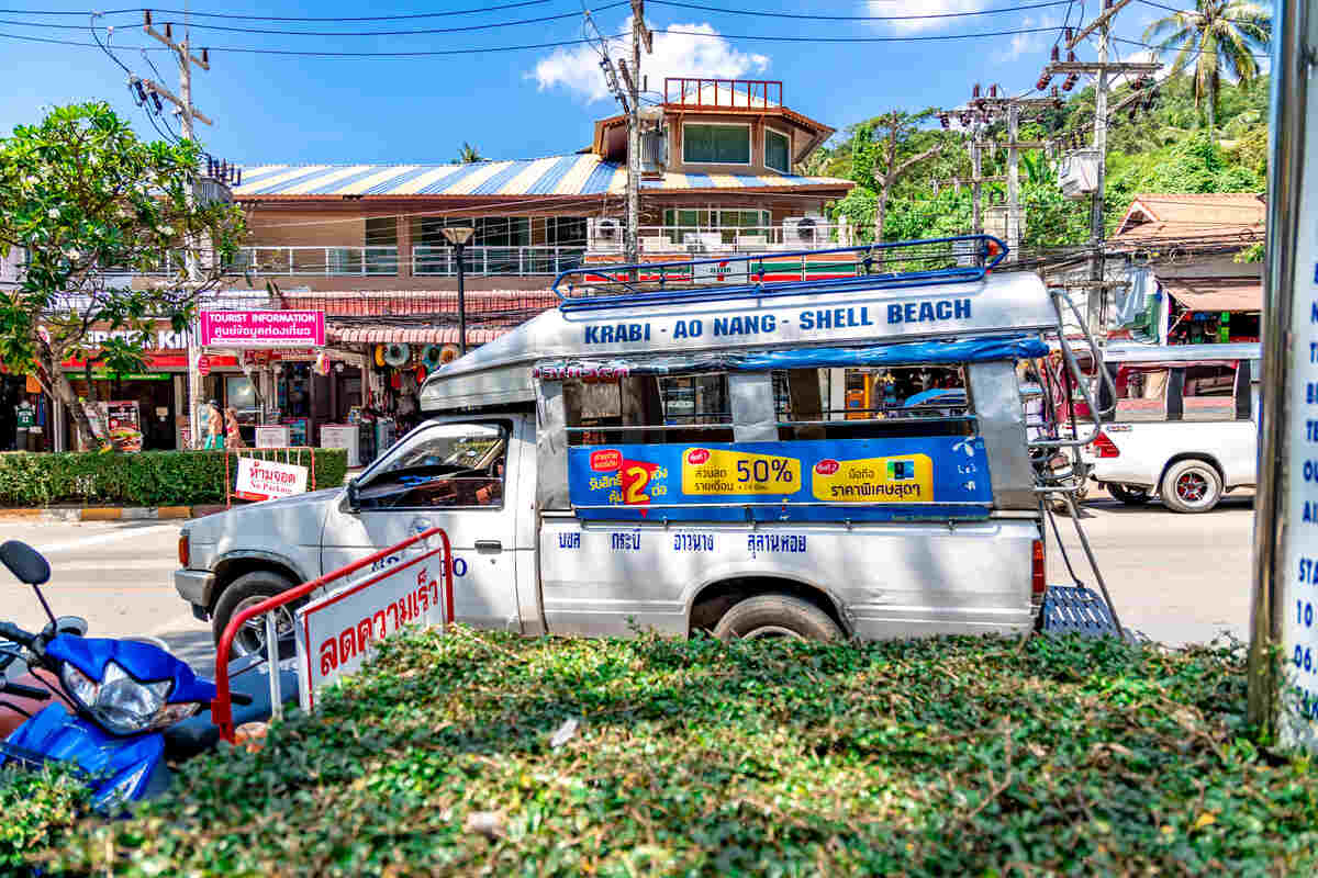 Colorful bus in a tropical setting in Krabi going from Krabi Ao Nang to Shell Beach.