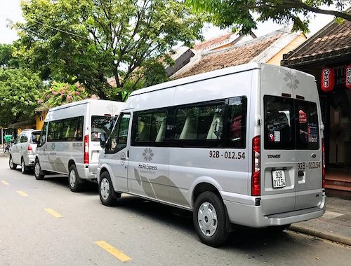 Vans and minibuses in a parking lot.