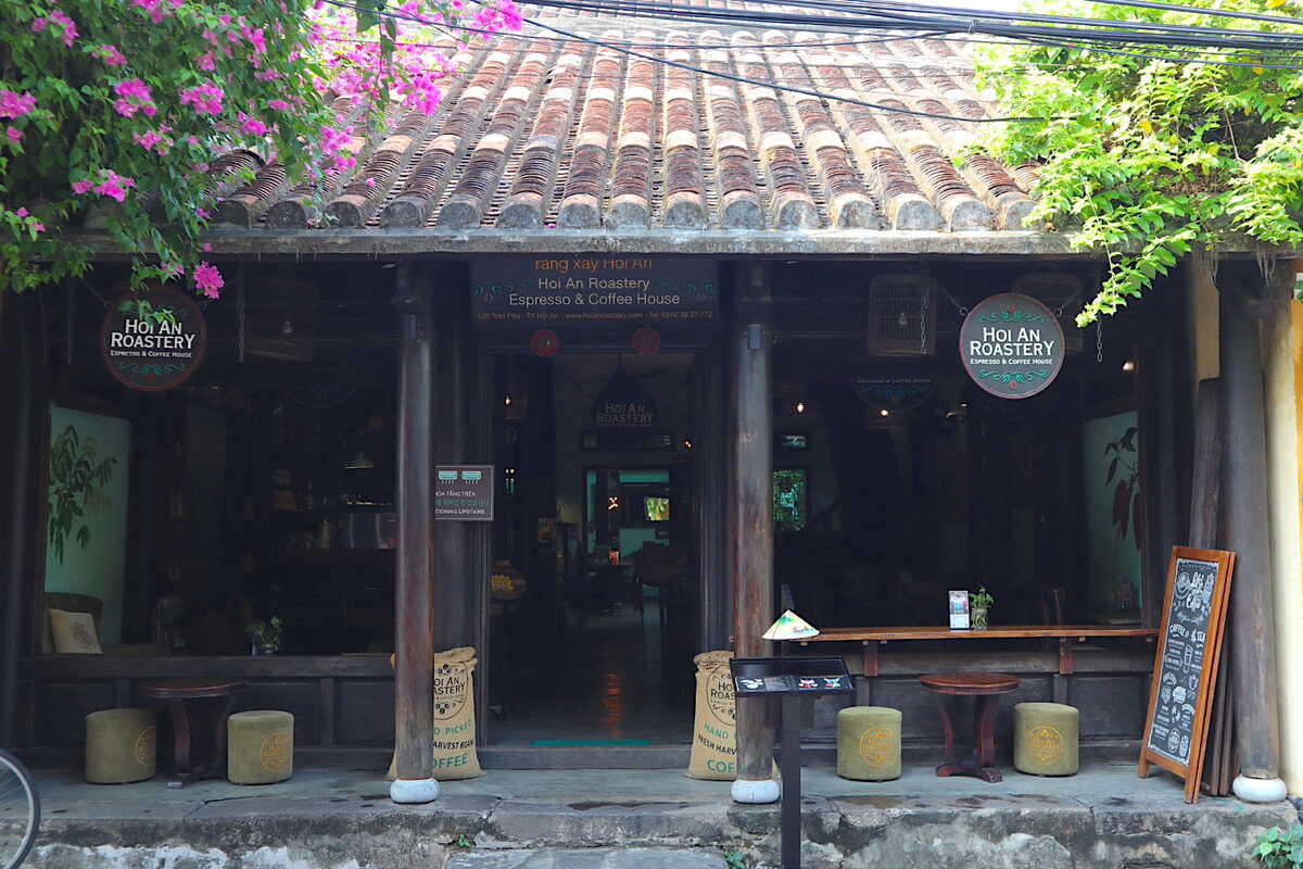 Coffee shop with tables outside and rustic charm.