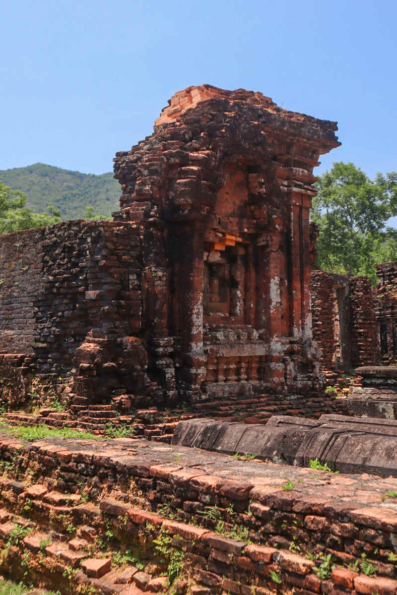 Ancient brick temple ruins with greenery.