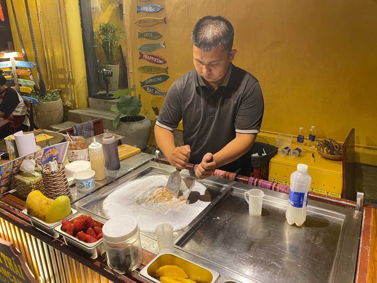 street vendor making ice cream on the street