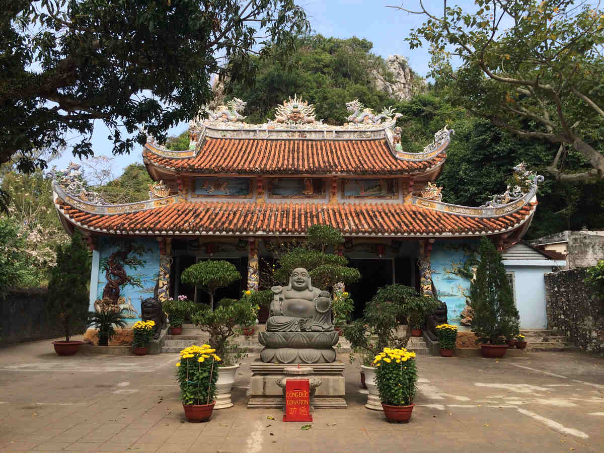 Entrance of a Buddhist temple with a Buddha image at the entrance on a sunny day