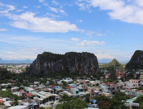 Aerial view of a rocky hill with buildings and a large church.