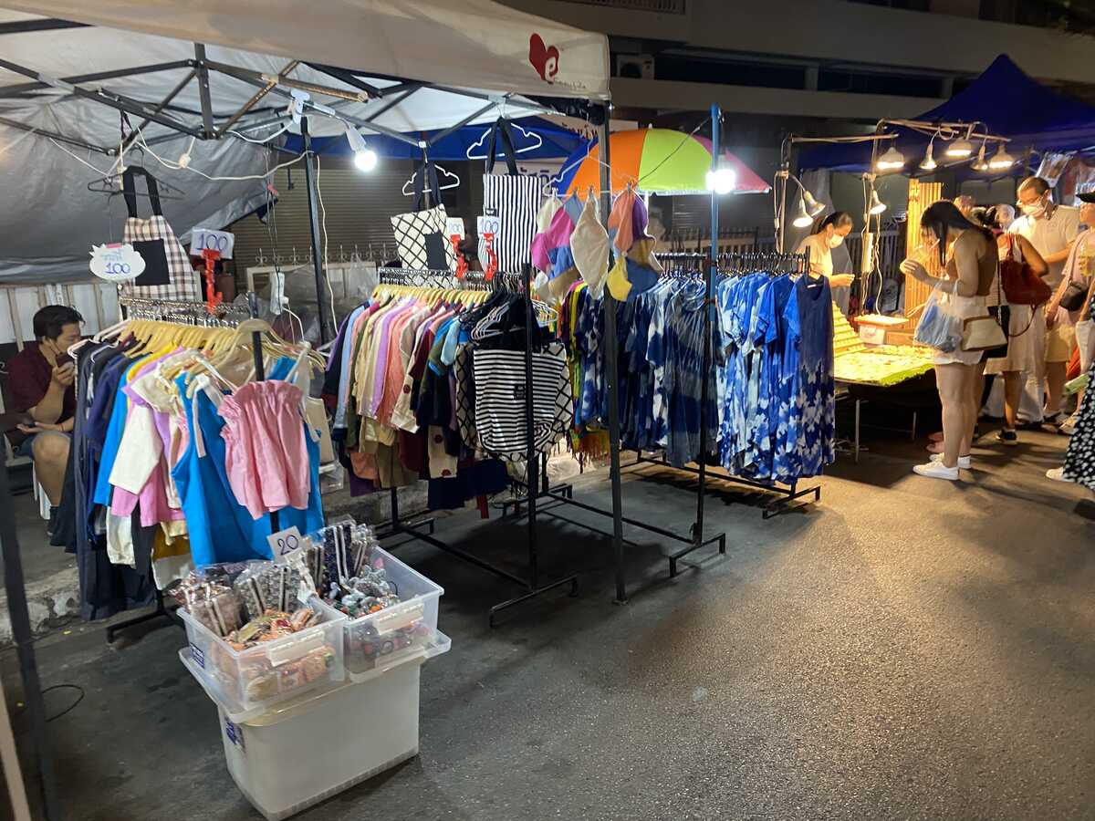 Colorful shirts displayed on a market stall.