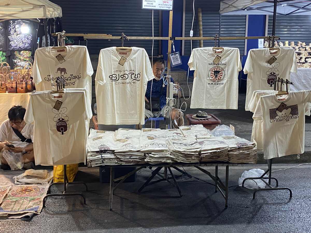 White shirts displayed on a market stall.