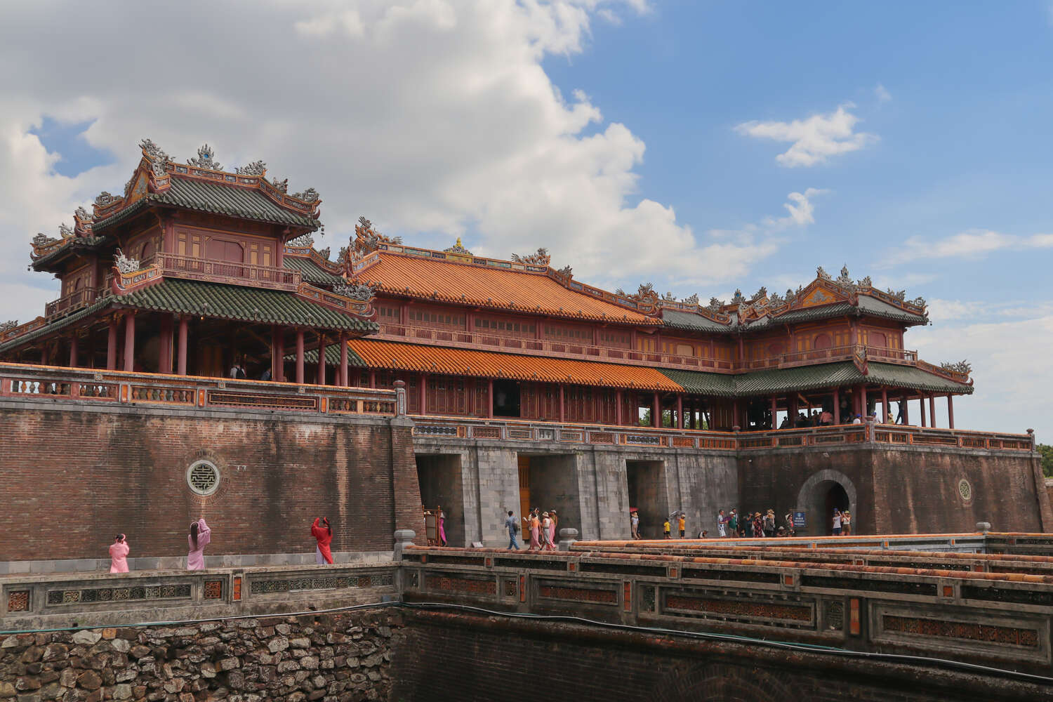 Traditional architecture of the Hue Imperial City with elaborate carvings and red lacquered columns.