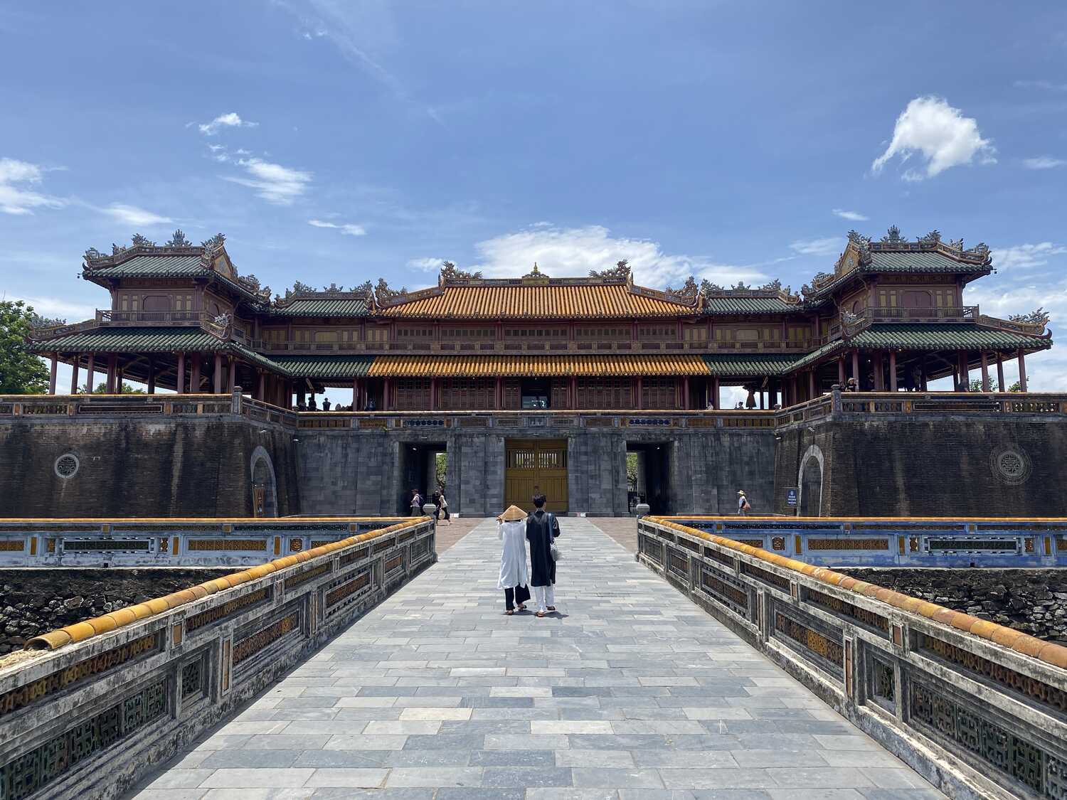 Symmetrical view through the gateways leading to the Hue Imperial City under a blue sky.