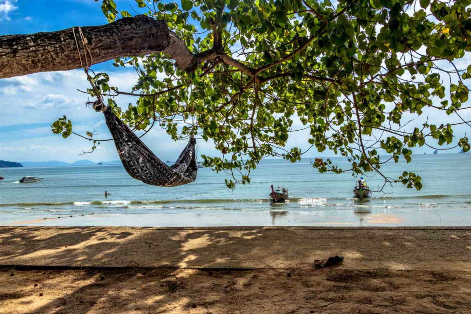 Hammock between palm trees by the sea in Ao Nang Beach Krabi