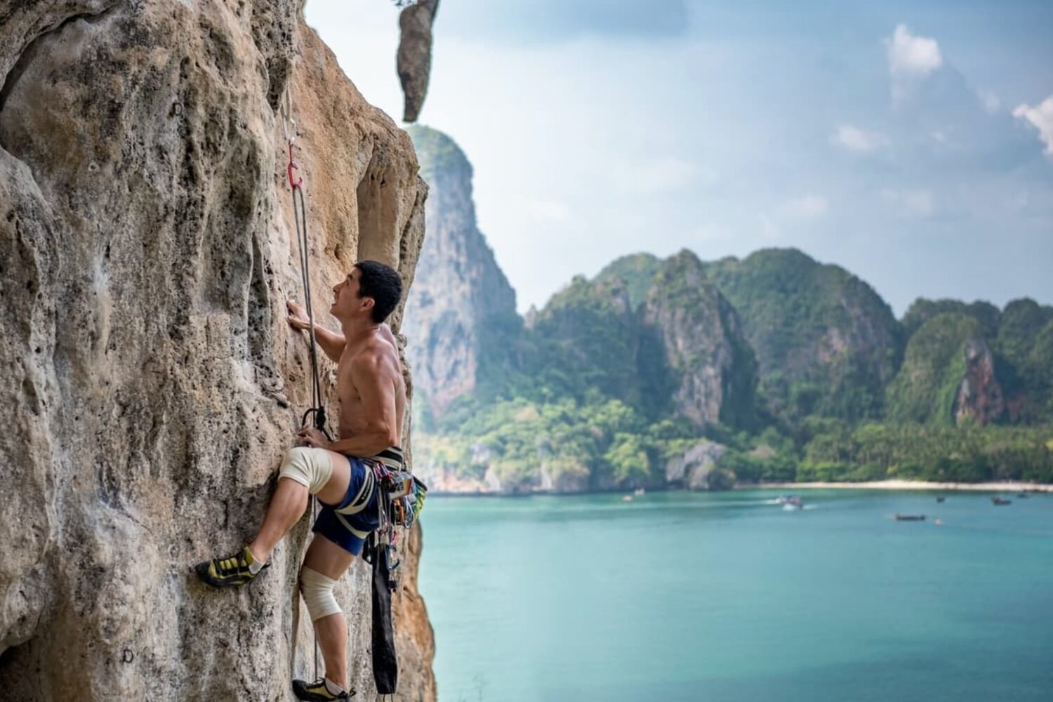 Man rock climbing in Railay Beach Thailand